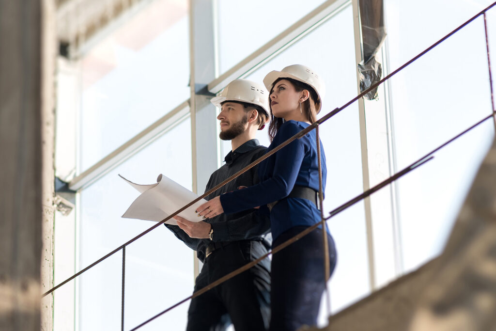 Two engineer-architects, a man and a woman discuss a constructio Architect lifts